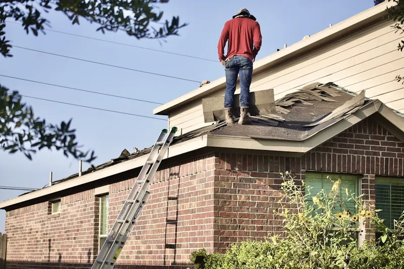 Professional roofer working on a residential roof in Downtown Hemet